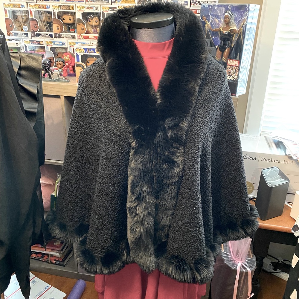 Faux fur trimmed wrap.